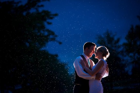 Rain drops sparkle in a rainy wedding portrait at SVSU in Saginaw, MI.